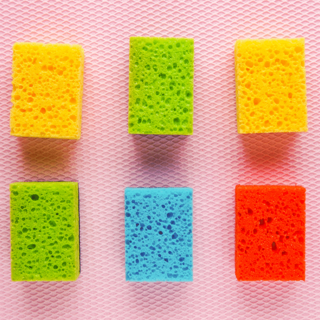 6 coloured sponges laid on a pink surface