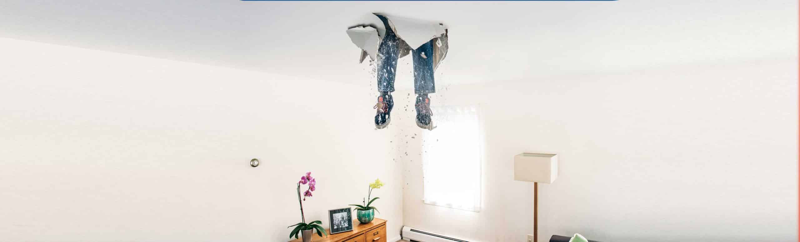Person falling through ceiling with legs sticking out in an open room