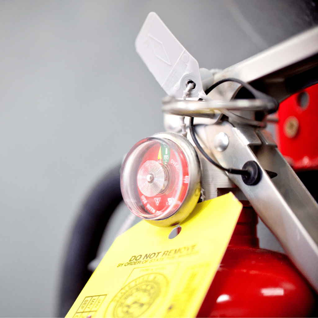 Close up of the top of a fire extinguisher