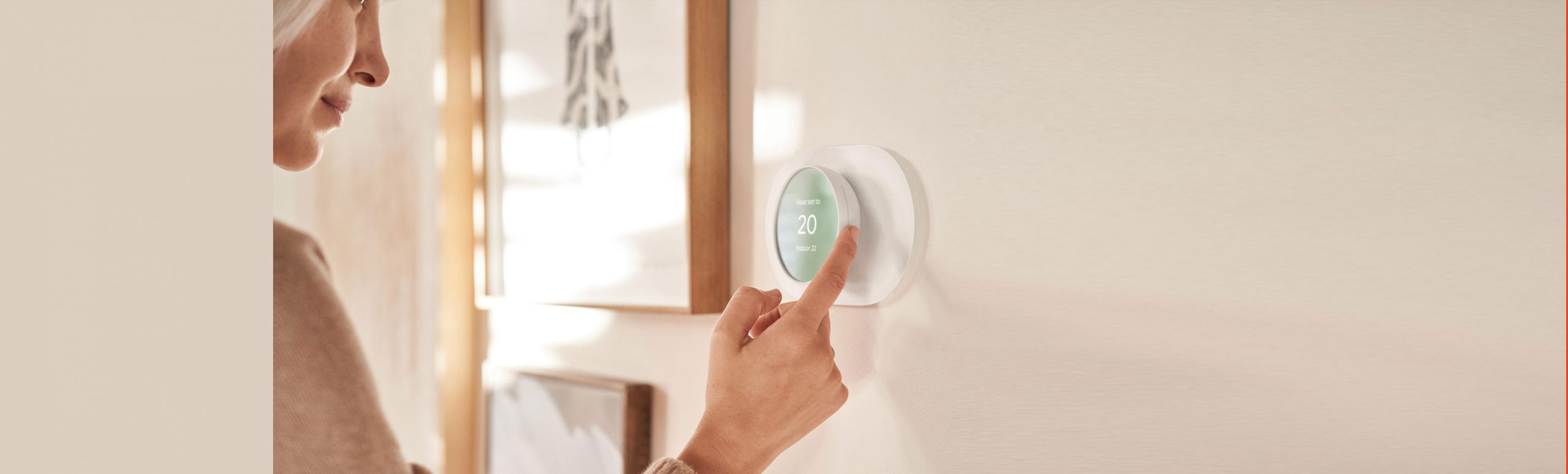 woman using google nest thermostat