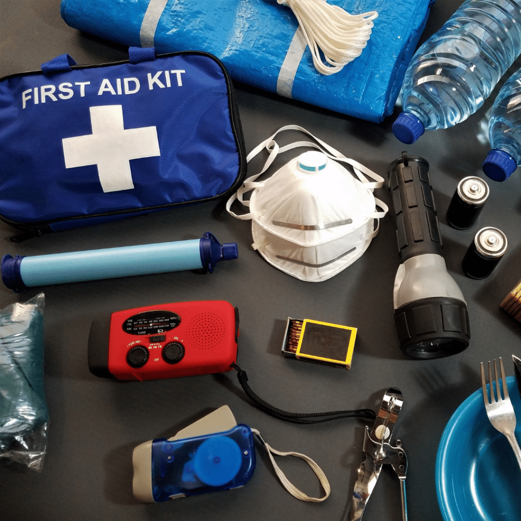 Emergency kit contents laid against a black surface