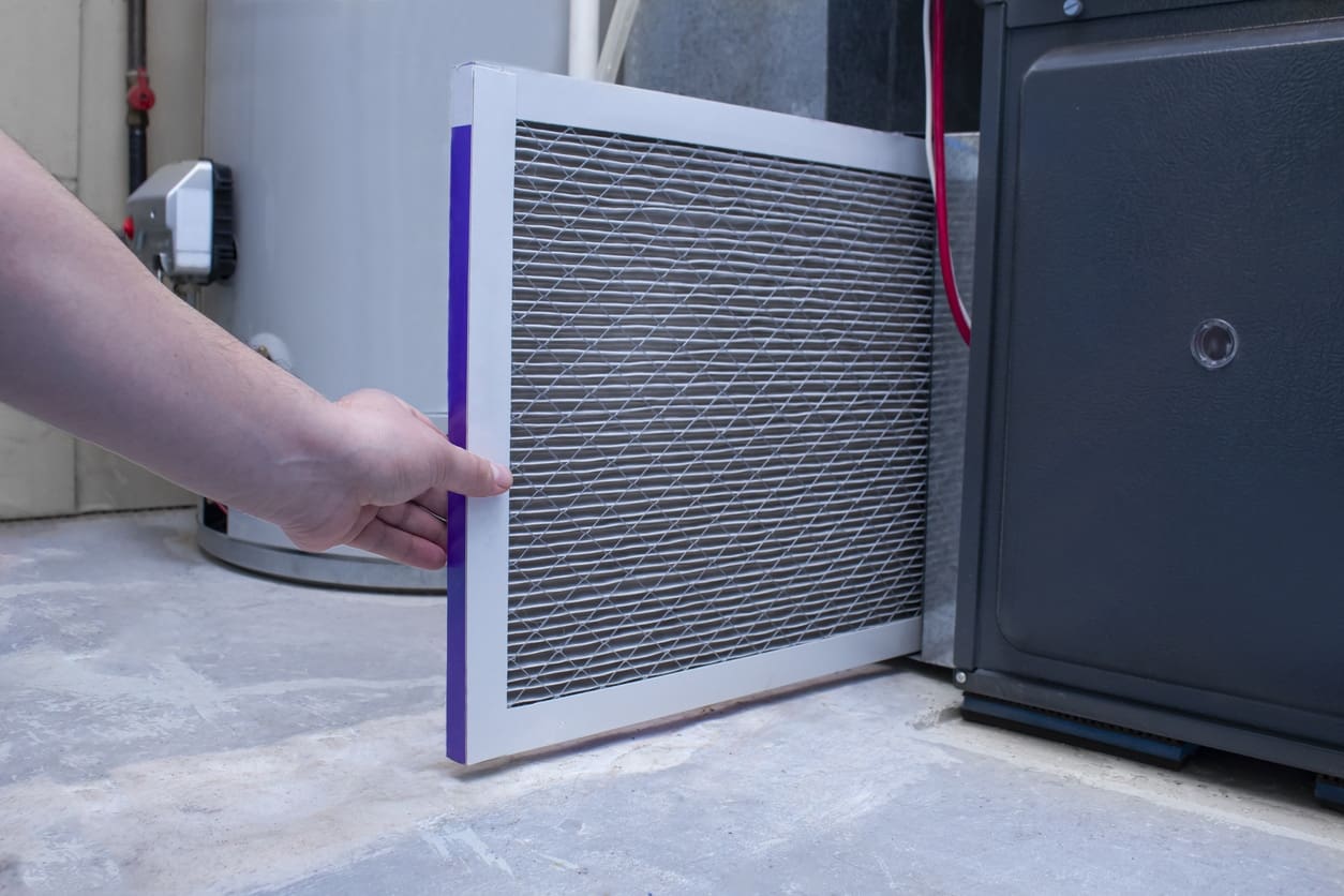 The 2024 Ultimate Furnace Guide Everything You Need To Know Before   A Person Changing An Air Filter On A High Efficiency Furnace 1308363658 1258x838 1 