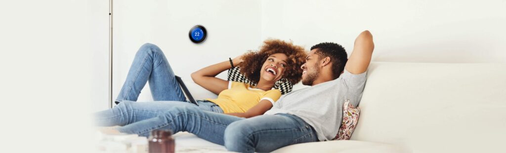 couple relaxing on the couch and smiling at eachother