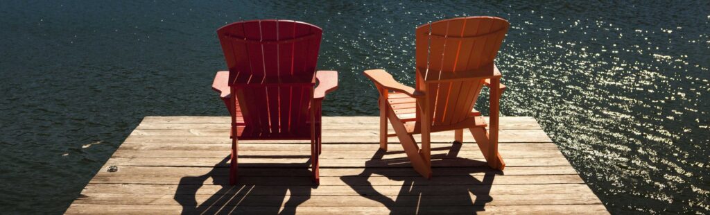 cottage dock with two red chairs