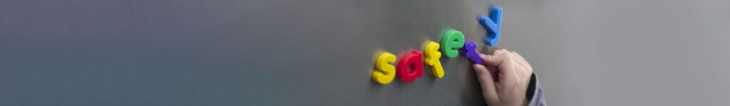 close up of letter magnets spelling "safety" on a silver surface