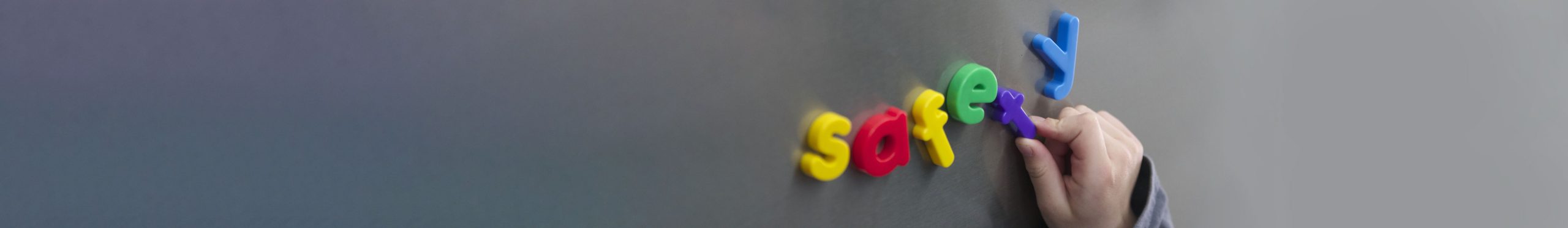 close up of letter magnets spelling "safety" on a silver surface