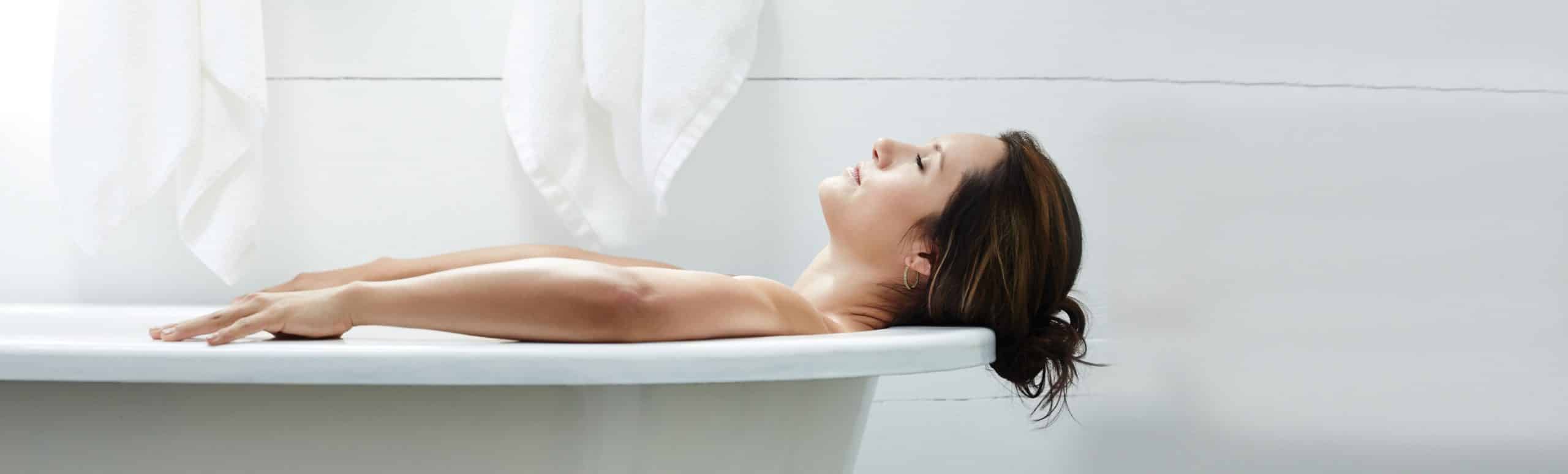 Person laying in a bathtub relaxed and looking upwards