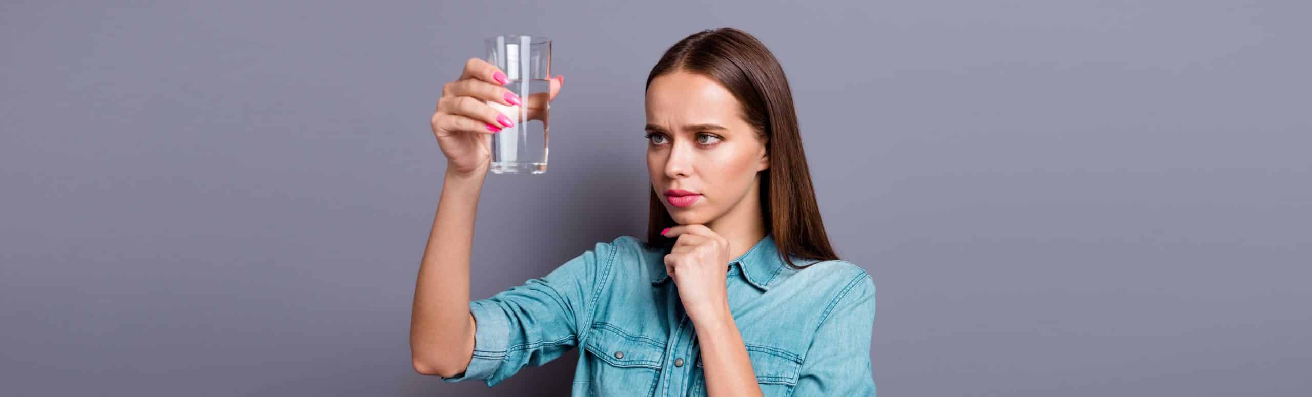 Woman analyzing a glass of water