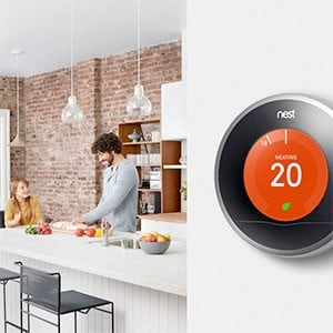 Nest learning thermostat on wall close to kitchen