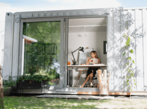 woman works on computer in her garden office