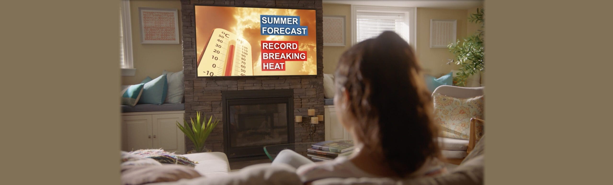 Summer forecast - Record breaking heat on tv with woman sitting on couch at home